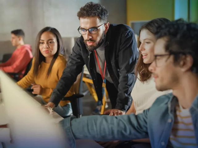 Trainer guiding a group through a software course